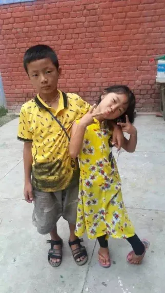 A young Tibetan child smiling outdoors