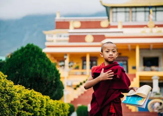 A young monk before his monastery